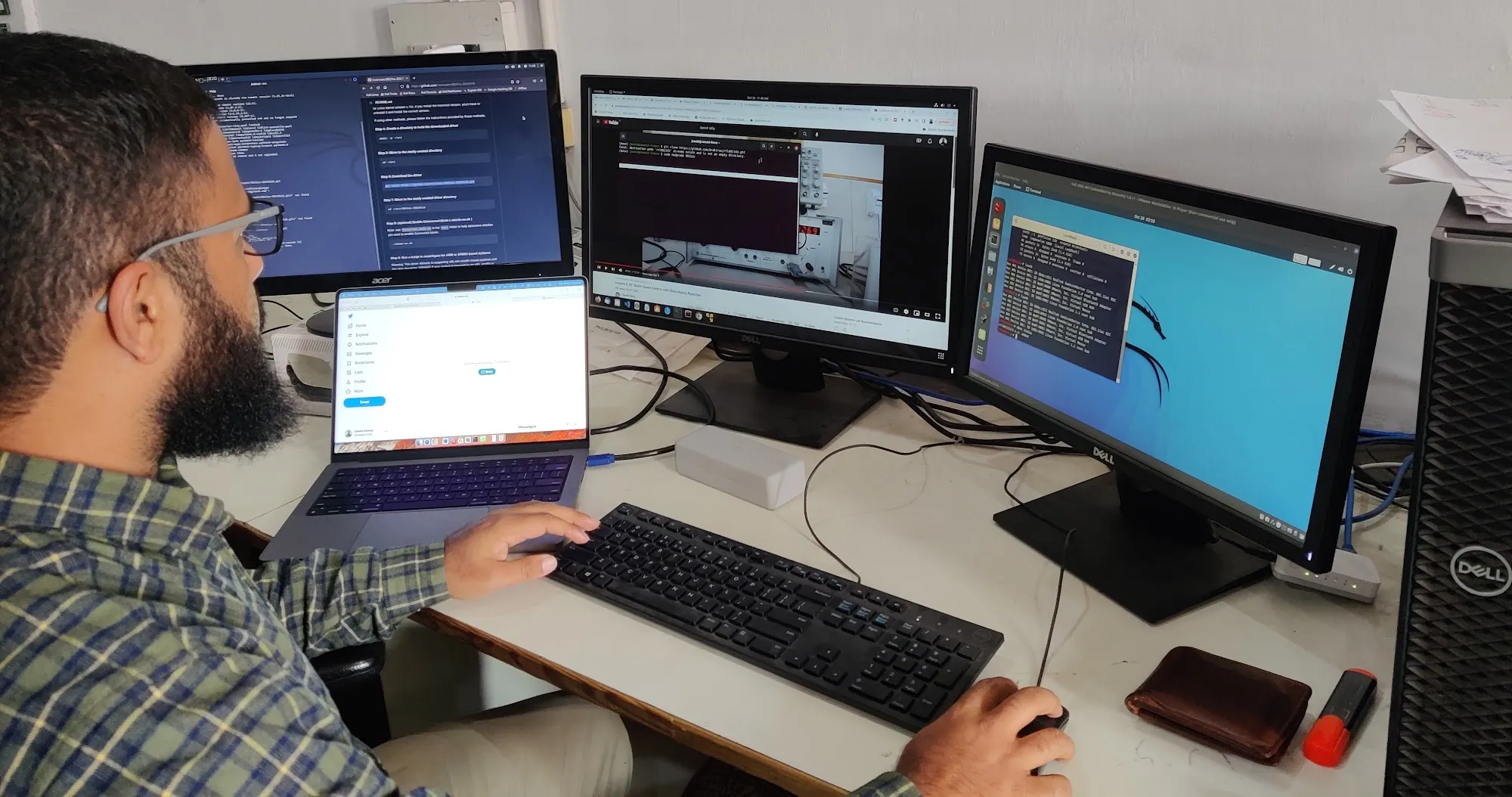 Junaid Farooq working at a multi-monitor workstation