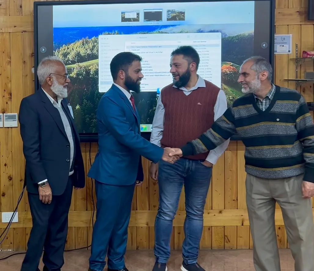 Junaid Farooq being congratulated after his PhD defense